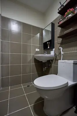 a bathroom with a white toilet and a sink at Vista Blooms Stay at Vista Shaw with WiFi in Manila