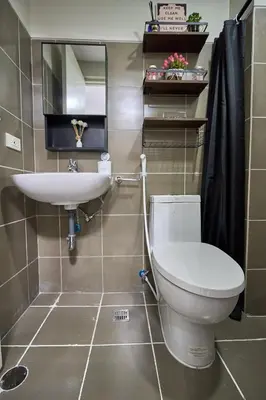 a bathroom with a toilet and a sink at Vista Blooms Stay at Vista Shaw with WiFi in Manila