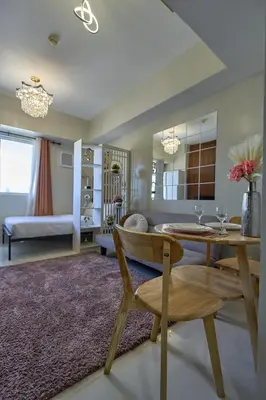 a living room with a table and a couch at Vista Blooms Stay at Vista Shaw with WiFi in Manila