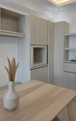 a kitchen with a wooden table with a vase on it at Center of BGC- Your Home In Forbeswood Parklane in Manila