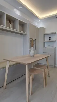 a dining room table with a vase on top of it at Center of BGC- Your Home In Forbeswood Parklane in Manila