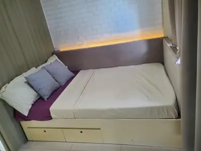 a small bed in a small room at SMDC Breeze Residences in Manila