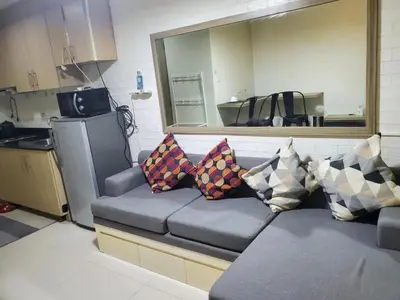 a couch with pillows on it in a kitchen at SMDC Breeze Residences in Manila