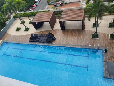 an overhead view of a pool with two benches and a table at SMDC Breeze Residences in Manila