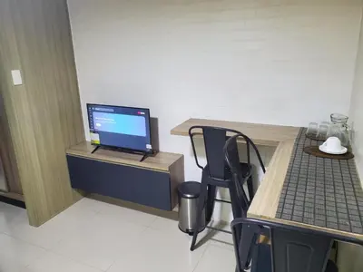 a room with a desk with a laptop computer on it at SMDC Breeze Residences in Manila