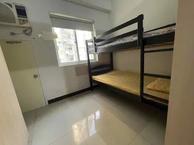 a small room with two bunk beds and a window at 1 BR Family Condo near NAIA behind SM Sucat Paranaque Manila Philippines in Manila