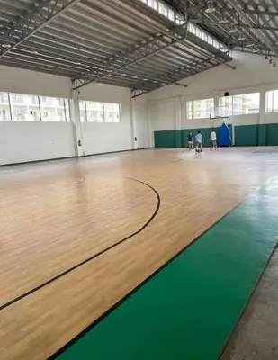 a gymnasium with a wooden floor and a basketball court at 1 BR Family Condo near NAIA behind SM Sucat Paranaque Manila Philippines in Manila