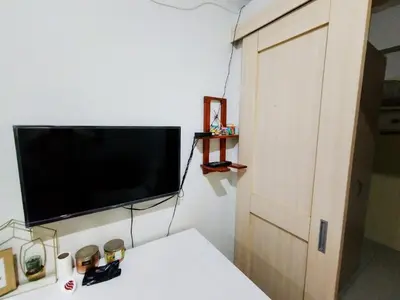 a room with a flat screen tv on a wall at 1 BR Family Condo near NAIA behind SM Sucat Paranaque Manila Philippines in Manila