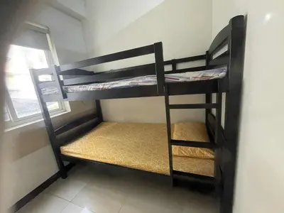 two bunk beds in a room with a window at 1 BR Family Condo near NAIA behind SM Sucat Paranaque Manila Philippines in Manila