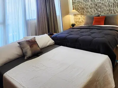 a bedroom with two beds in a room with a bed at 29c BGC Cozy Suite Steps Away From Major Malls with Paid Parking and Gym with Fast Wi-fi in Manila