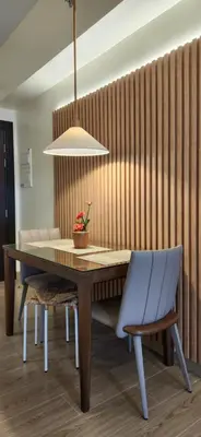 a dining room table with a blue chair and a lamp at 29c BGC Cozy Suite Steps Away From Major Malls with Paid Parking and Gym with Fast Wi-fi in Manila