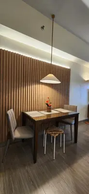 a dining room with a table and a chair at 29c BGC Cozy Suite Steps Away From Major Malls with Paid Parking and Gym with Fast Wi-fi in Manila
