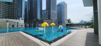 a pool with a playground in the middle of a city at 29c BGC Cozy Suite Steps Away From Major Malls with Paid Parking and Gym with Fast Wi-fi in Manila