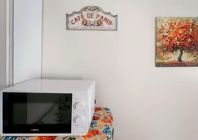 a microwave oven sitting on top of a couch at Colin's Suite - Hope Residences, Trece Martires in Trece Martires