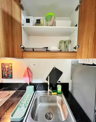 a kitchen with a sink and a counter top at Shore Residence hosted by Nara Homes in Manila