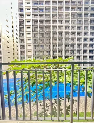 a view of a large building from a balcony at Shore Residence hosted by Nara Homes in Manila