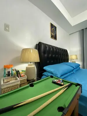 a bedroom with a pool table and a bed at Azure Daily by Trisha Sarmiento in Manila