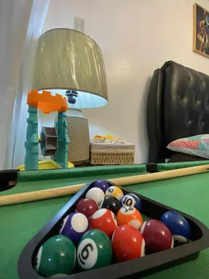 a room with a pool table with billiard balls at Azure Daily by Trisha Sarmiento in Manila