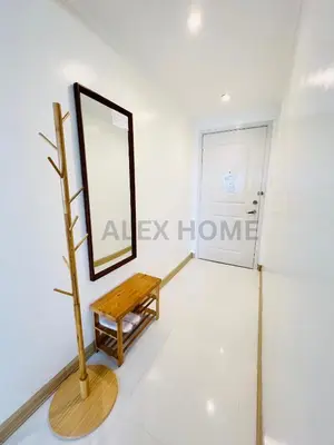 a dressing room with a bench and a mirror at Alex Staycation Home in BGC in Manila