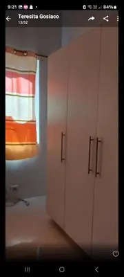 a bathroom with white cabinets and a window at Sea Residences By Queen in Manila
