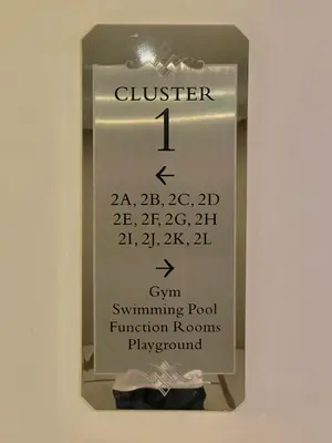 a sign on a wall with a box with a button at 101 Newport Blvd - SkyBison Aerie Condo Across NAIA T3 in Manila
