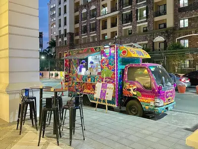 a colorful food truck parked next to a street at 101 Newport Blvd - SkyBison Aerie Condo Across NAIA T3 in Manila