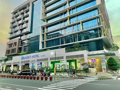 a large building with people walking in front of it at 101 Newport Blvd - SkyBison Aerie Condo Across NAIA T3 in Manila
