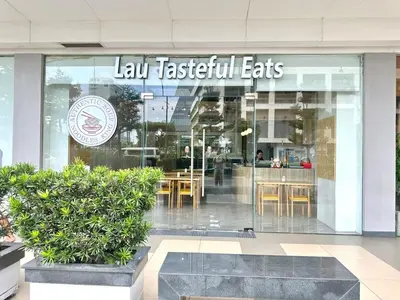 a restaurant with a sign on the front of a building at Apartment near MOA & Airport in Manila