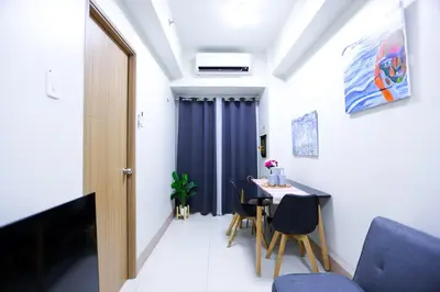 a small dining room with a table and chairs at Apartment near MOA & Airport in Manila
