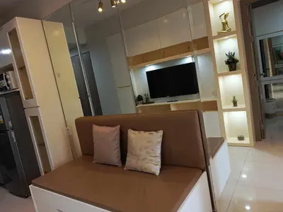 a couch with two pillows on it in a living room at S Residences Room 910B near MOA, IKEA & NAIA by Prime Stay in Manila