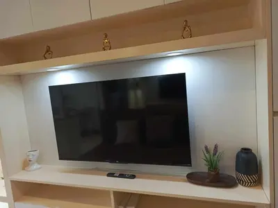 a large flat screen tv sitting on a shelf at S Residences Room 910B near MOA, IKEA & NAIA by Prime Stay in Manila