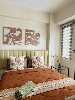 a bedroom with a large orange bed with pillows at Kai cabins NAIA 3 walking distance Newport City Pasay in Manila