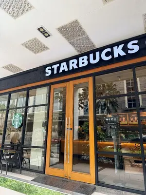 a starbucks sign on the side of a building at Kai cabins NAIA 3 walking distance Newport City Pasay in Manila