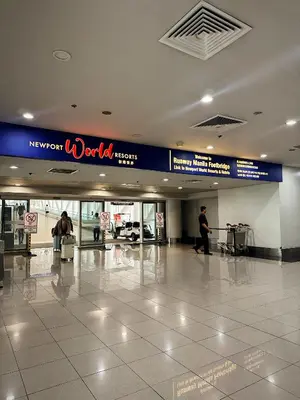 a lobby of an airport with people walking around at Kai cabins NAIA 3 walking distance Newport City Pasay in Manila