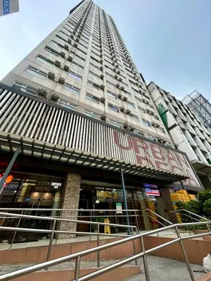 a tall building with a pyramid top at The View Studio in Urban Deca Tower EDSA in Manila