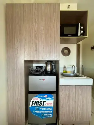 a box of first aid next to a stove in a kitchen at The View Studio in Urban Deca Tower EDSA in Manila