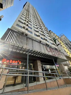 a tall building with a pyramid top at The View Studio in Urban Deca Tower EDSA in Manila