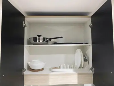 a kitchen with a shelf with a sink and utensils at Kasara Urban Residences in Pasig City - Solmera Cove in Manila