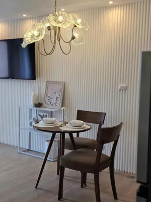 a dining room table with chairs and a chandelier at Luxurious Balcony Venice Grand Canal View in Manila