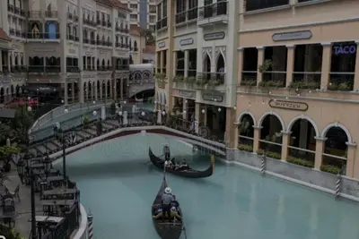 two gondolas in a canal in a shopping mall at Luxurious Balcony Venice Grand Canal View in Manila