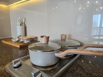 a kitchen counter with two pots and pans on a stove at Luxurious Balcony Venice Grand Canal View in Manila