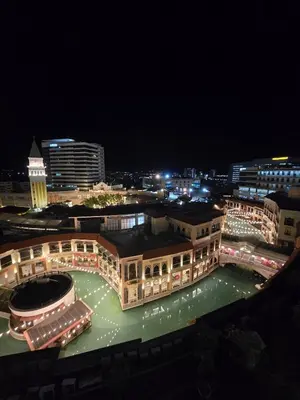 a large building at night with lights on at Luxurious Balcony Venice Grand Canal View in Manila