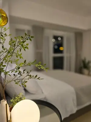 a bedroom with a bed and a table with a plant at Luxurious Balcony Venice Grand Canal View in Manila