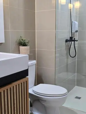 a bathroom with a toilet and a shower and a sink at Luxurious Balcony Venice Grand Canal View in Manila