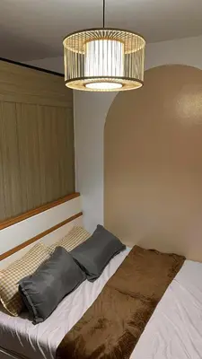 a bedroom with a bed and a chandelier at Family Room Staycation Shore Residences Near Mall of Asia and Airport Adjacent Units - Perfect for Groups in Manila