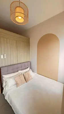 a bed with two pillows on it in a room at Family Room Staycation Shore Residences Near Mall of Asia and Airport Adjacent Units - Perfect for Groups in Manila