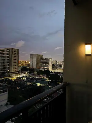 a view of a city at night from a balcony at Kai cabins SELF CHECK IN NEAR NAIA 1 & 2 in Manila