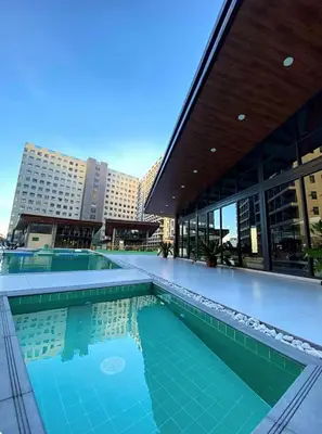 a large swimming pool in front of a building at Kai cabins SELF CHECK IN NEAR NAIA 1 & 2 in Manila