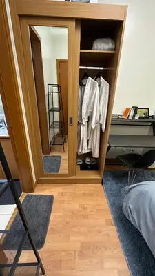 a room with a closet with a mirror and a desk at Classy BGC Condo City View Pool Gym Sauna in Manila