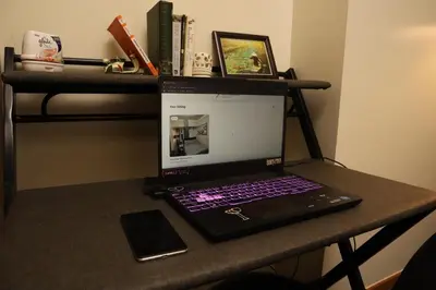 a laptop computer sitting on top of a desk at Classy BGC Condo City View Pool Gym Sauna in Manila